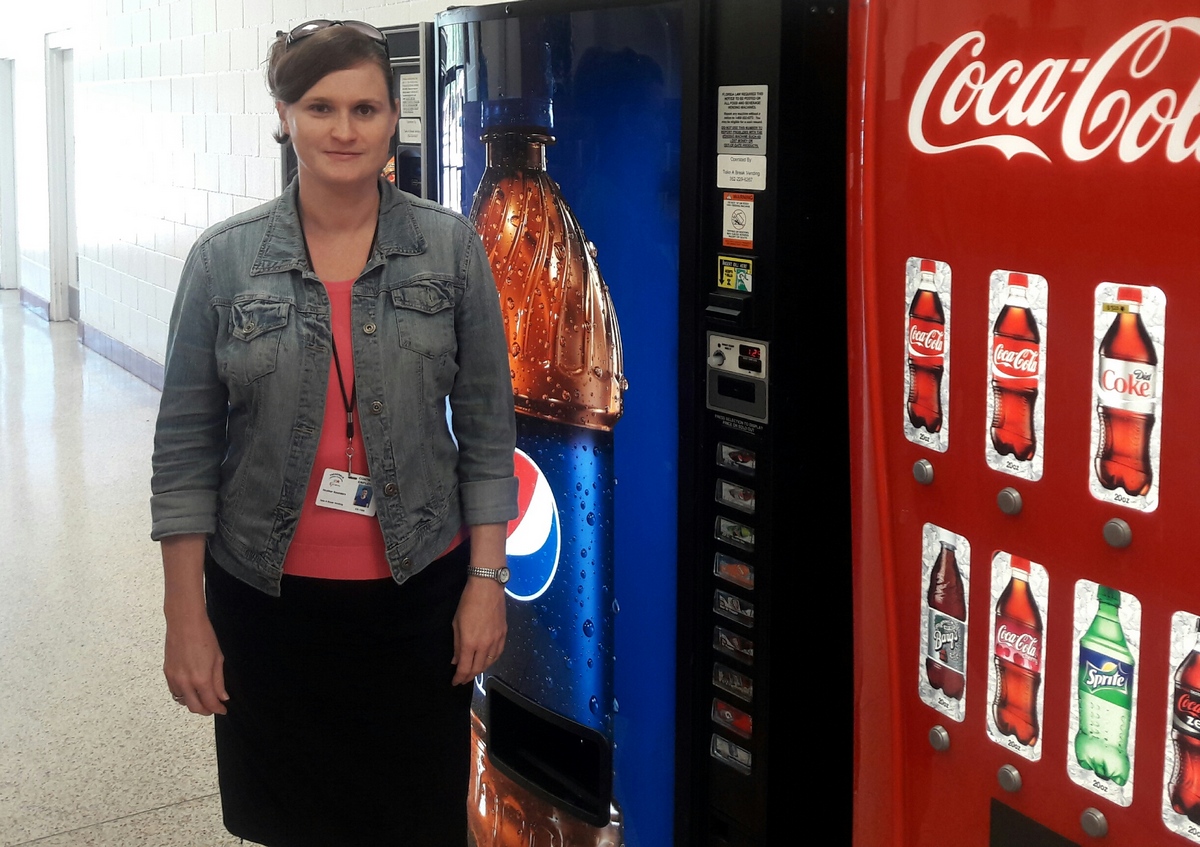 BBE Vendor Heather Saunders standing next to a soda machine. 
